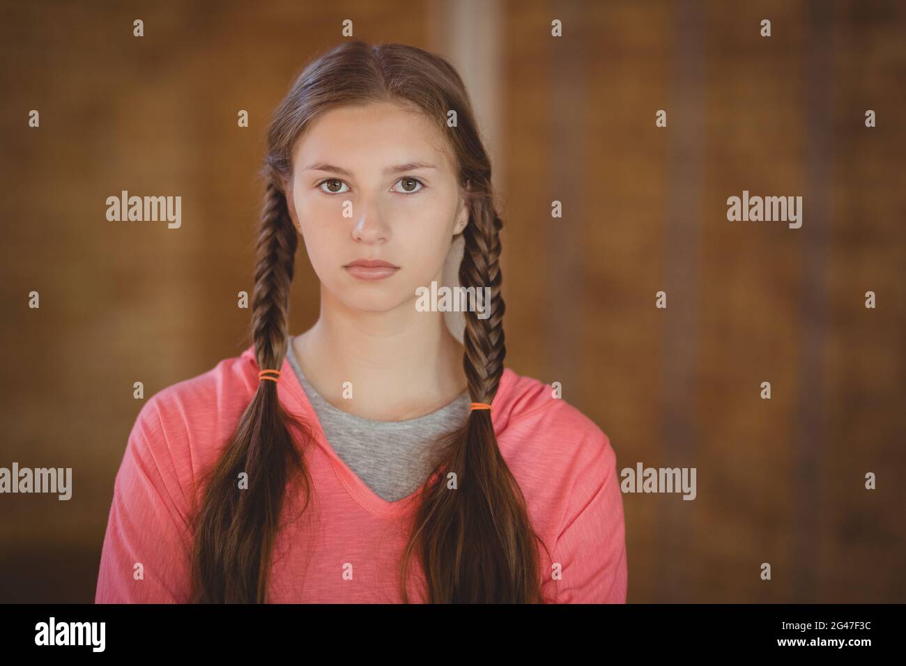 High school girl standing in basketball court Stock Photo