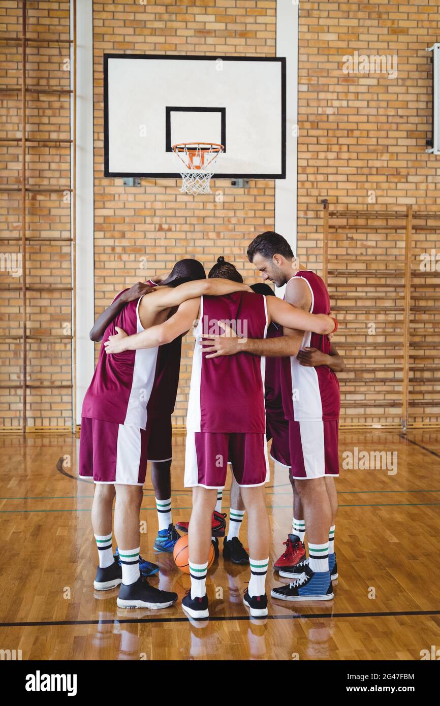 Basketball players forming a huddle Stock Photo Alamy