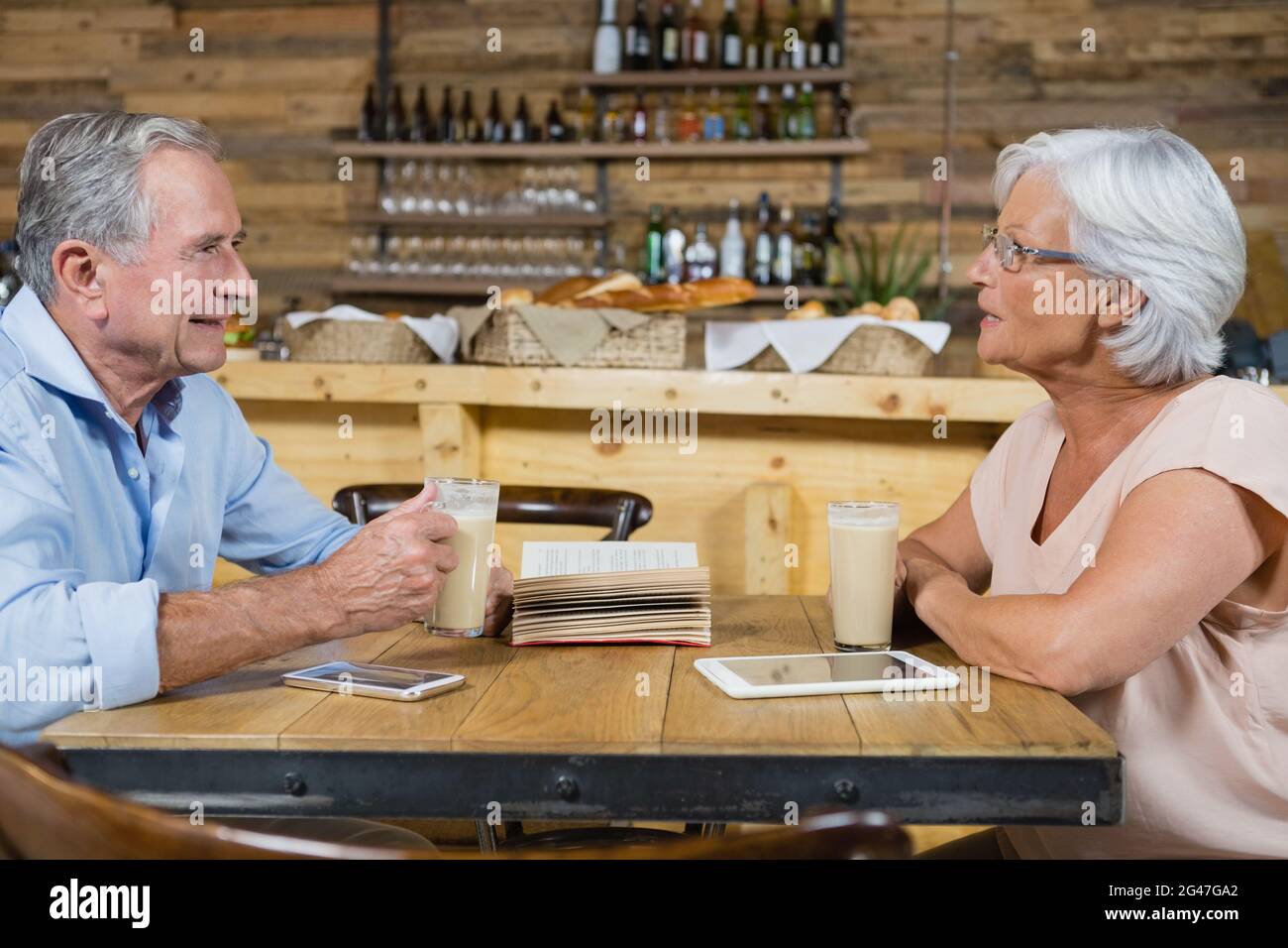 Senior couple interacting while having coffee Stock Photo