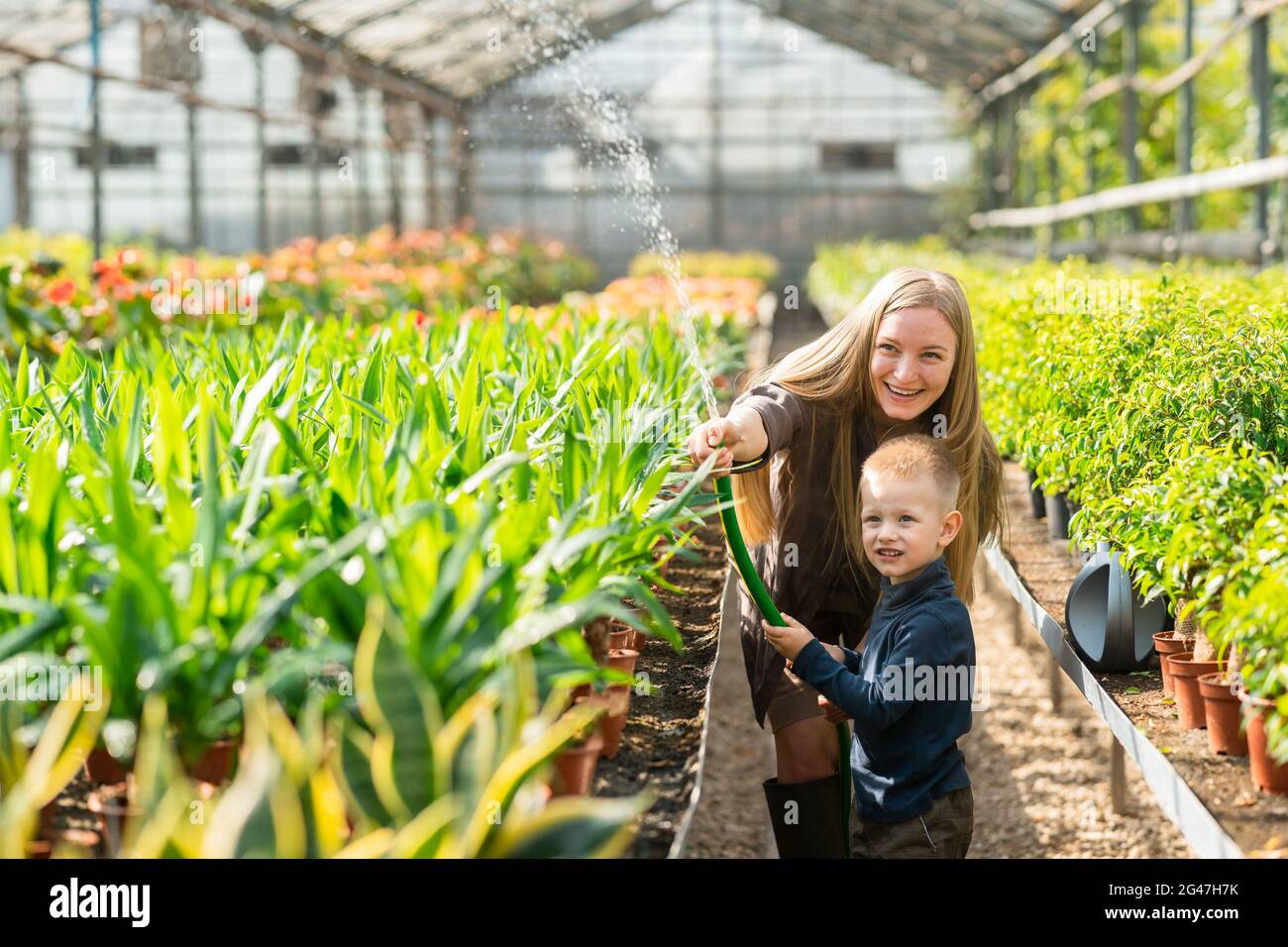 Girl and boy watering plants hi-res stock photography and images - Alamy