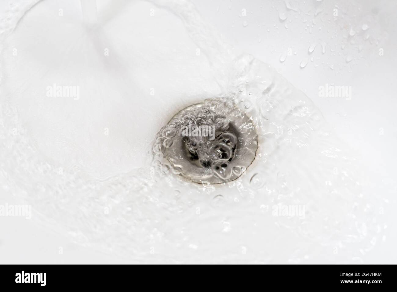 water draining from sink, pouring liquid in the hole Stock Photo Alamy