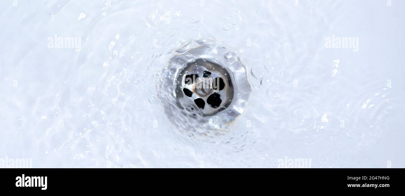 water draining from sink, pouring liquid in the hole Stock Photo Alamy