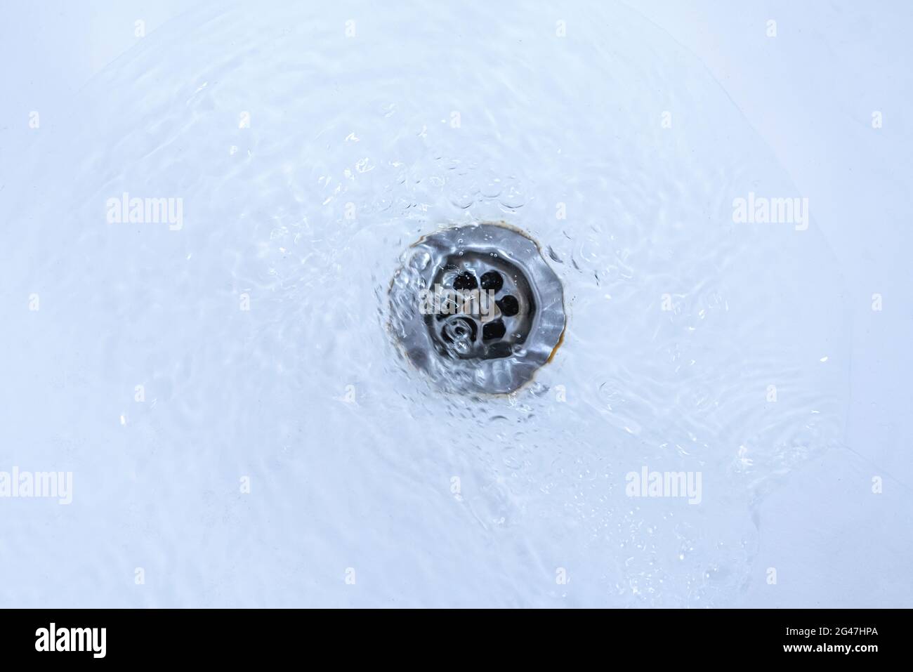water draining from sink, pouring liquid in the hole Stock Photo Alamy