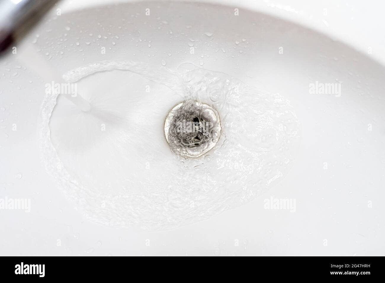 water draining from sink, pouring liquid in the hole Stock Photo Alamy