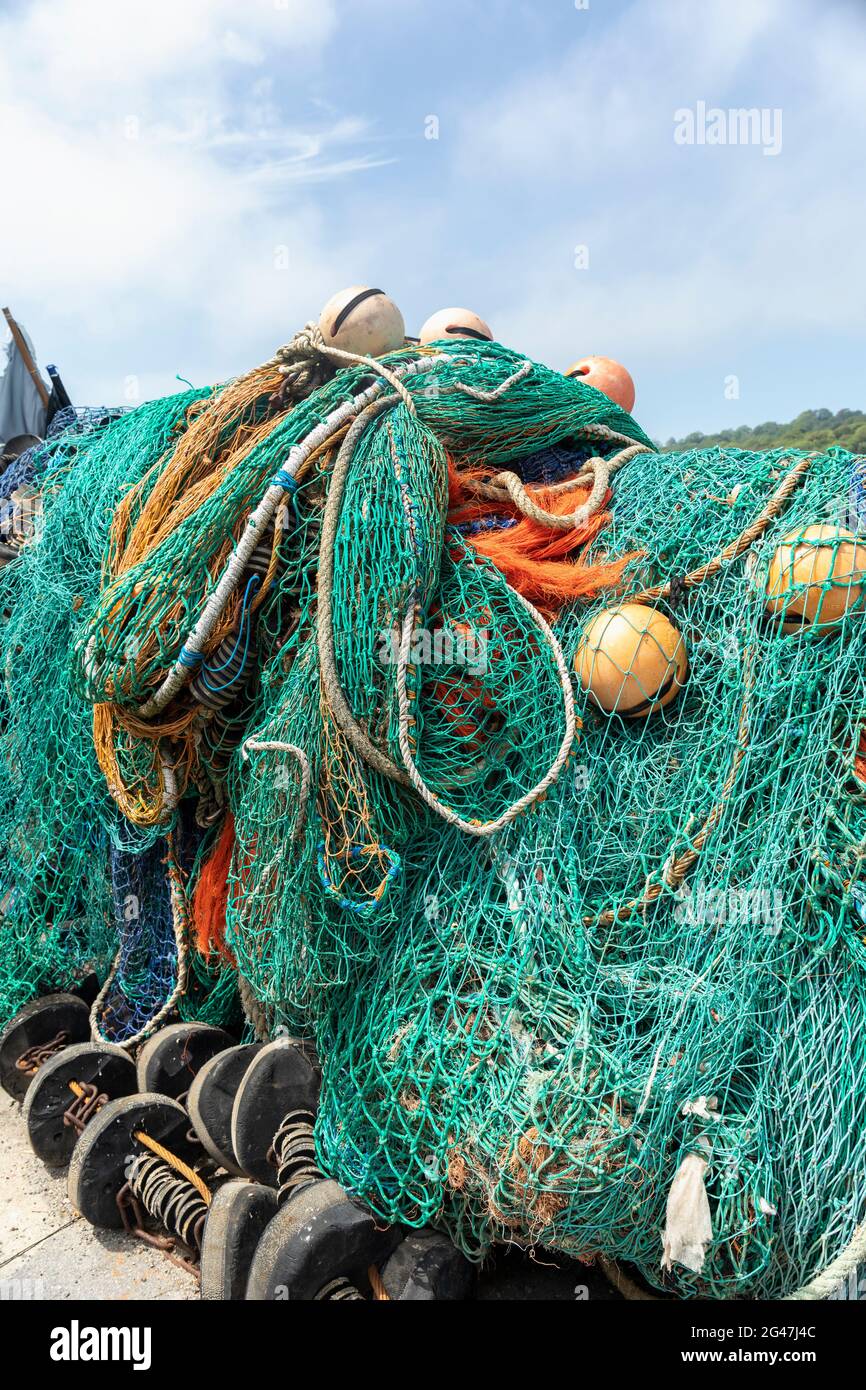 Quayside fishing nets and buoys on The Cobb at Lyme Regis, Dorset, England, UK Stock Photo