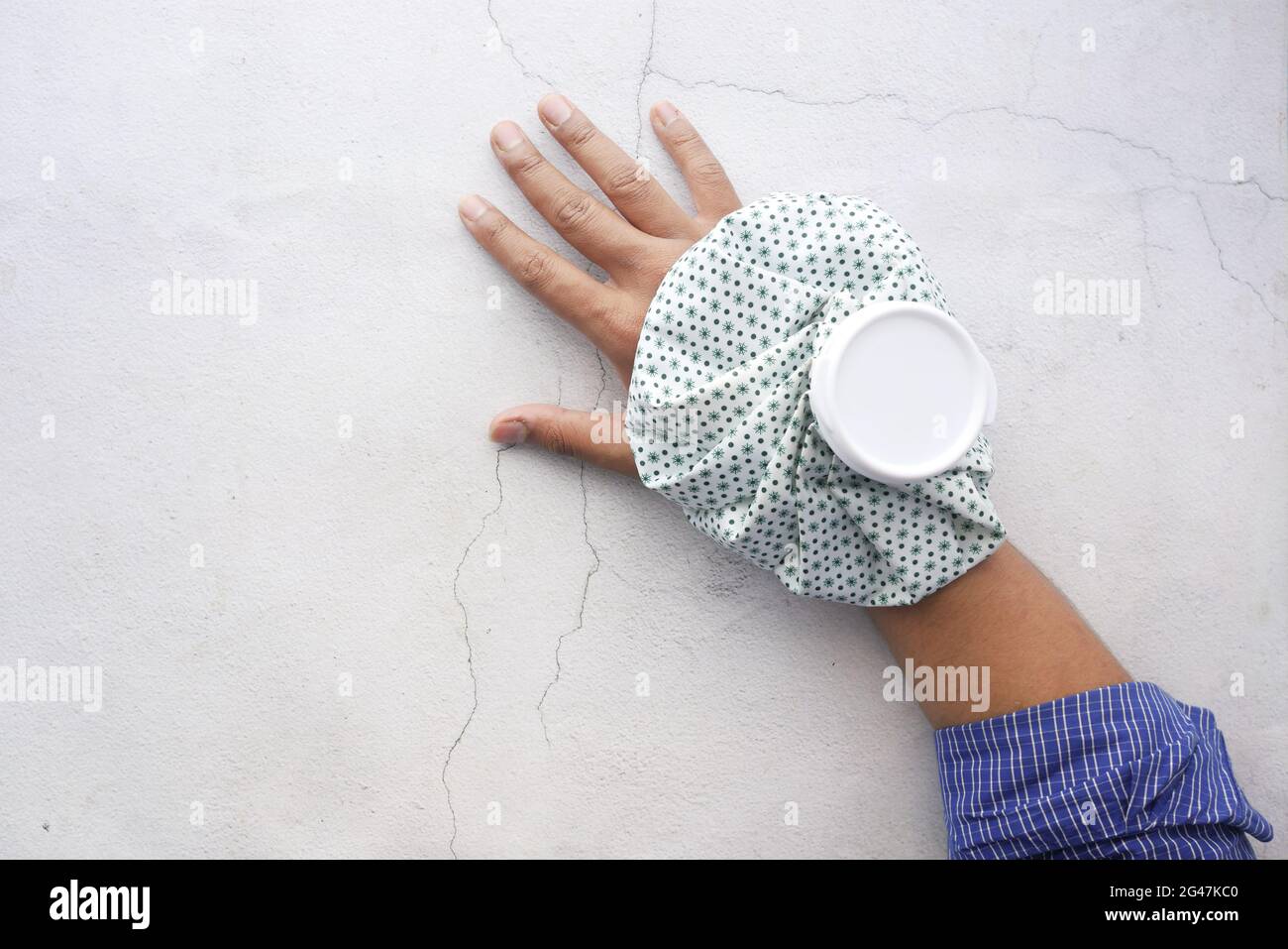 Young man hands suffering wrist pain, and applying cold water on injury