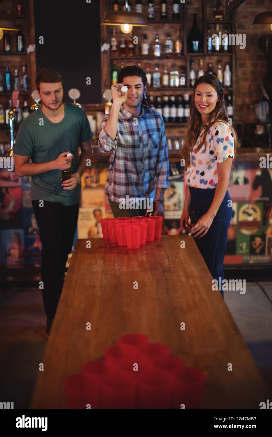 Group of happy friends playing beer pong game Stock Photo Alamy