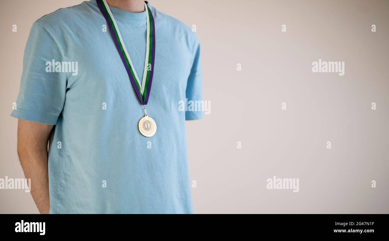 male sportsman with a golden medal on a chest, champion leader Stock Photo