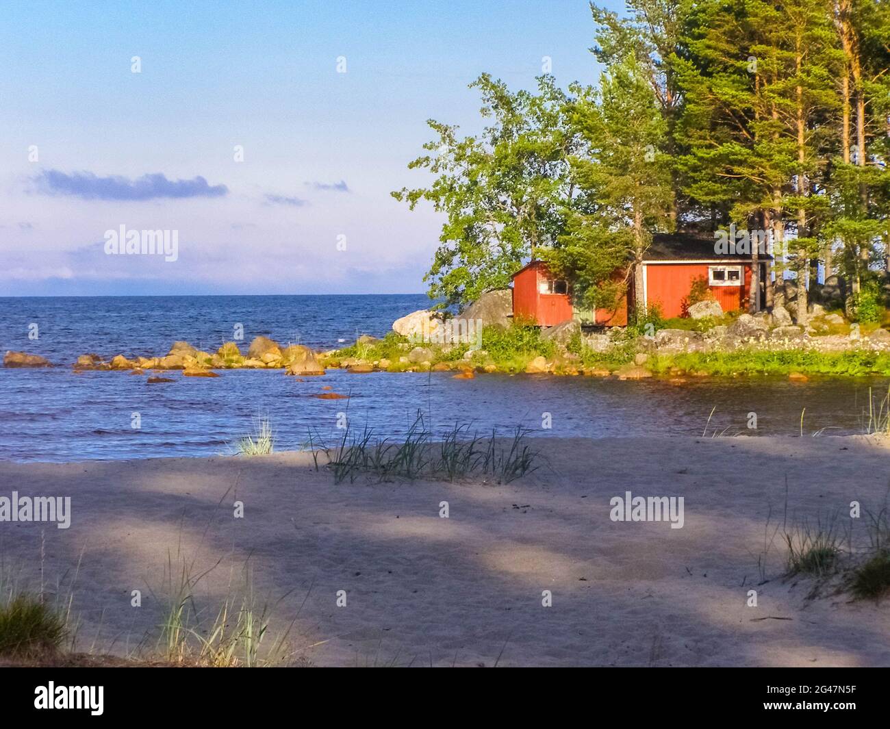 A classical red swedish cabin on the countryside. Stock Photo