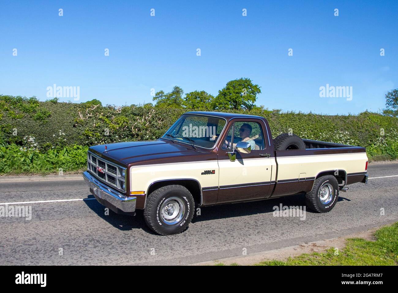 1984 eighties 80s brown cream Chevrolet Chevy American GMC USA work Truck en-route to Capesthorne Hall classic May car show, Cheshire, UK Stock Photo