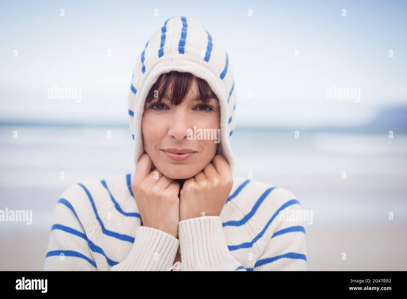 Portrait of woman wearing hooded sweater during winter Stock Photo