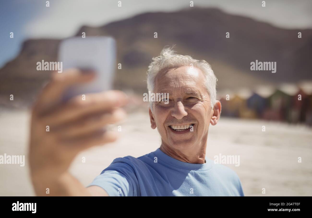 Happy senior man taking selfie at beach Stock Photo - Alamy