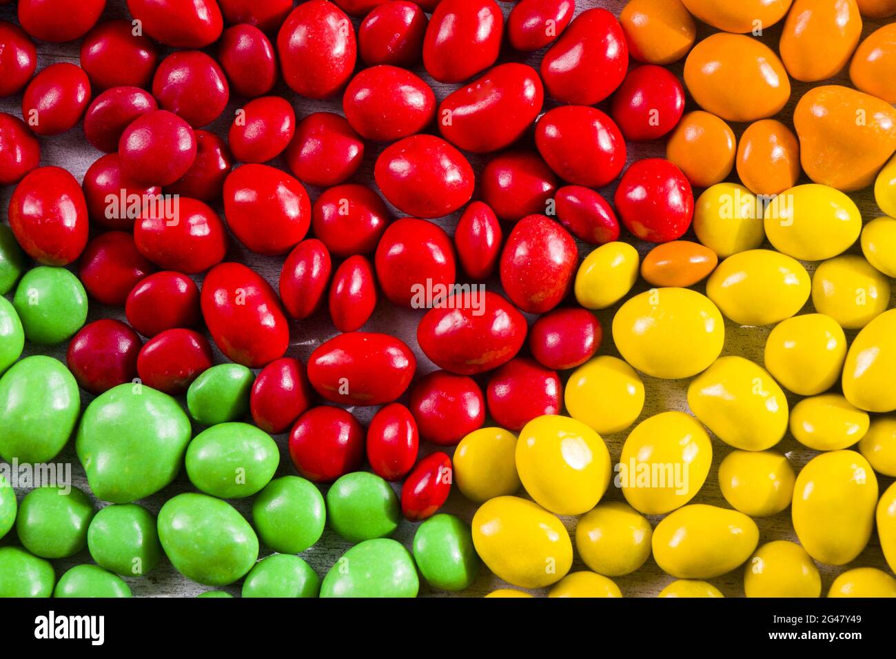 Top view of a group of colorful sweet candies scattered on the table ...