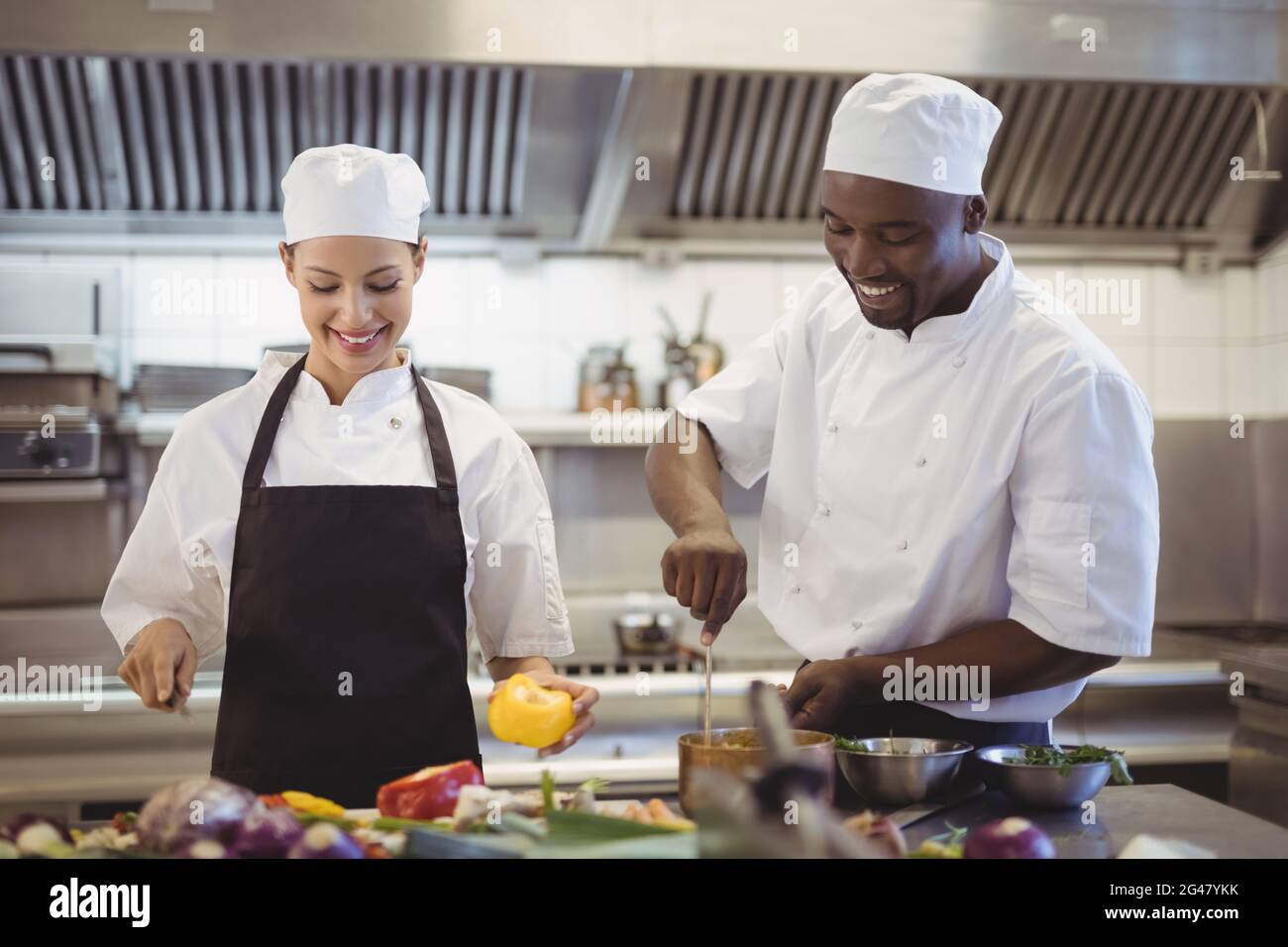 Chefs preparing food in the commercial kitchen Stock Photo - Alamy