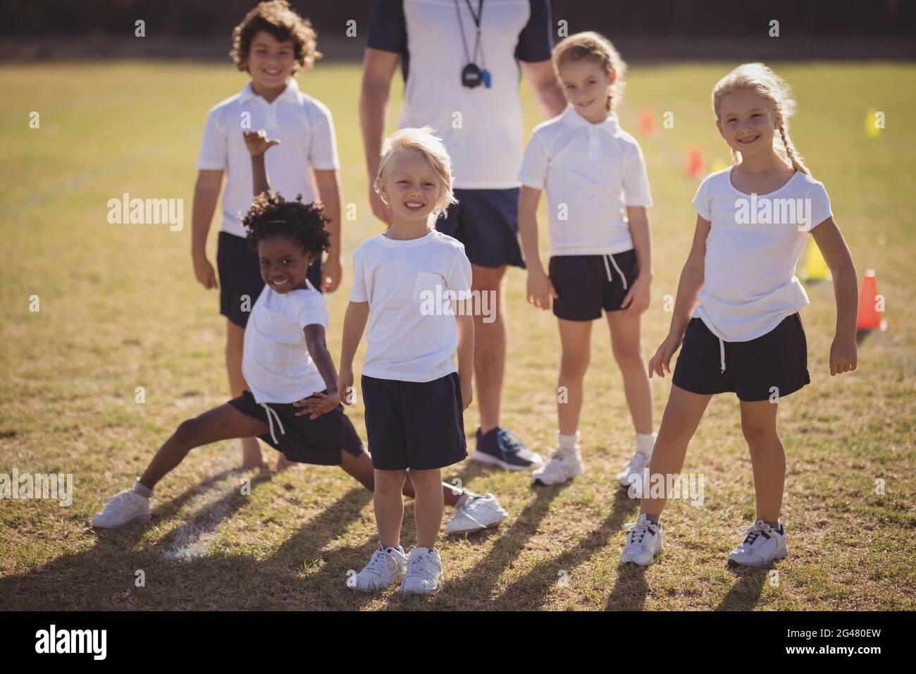 Portrait of schoolgirls standing in park Stock Photo - Alamy
