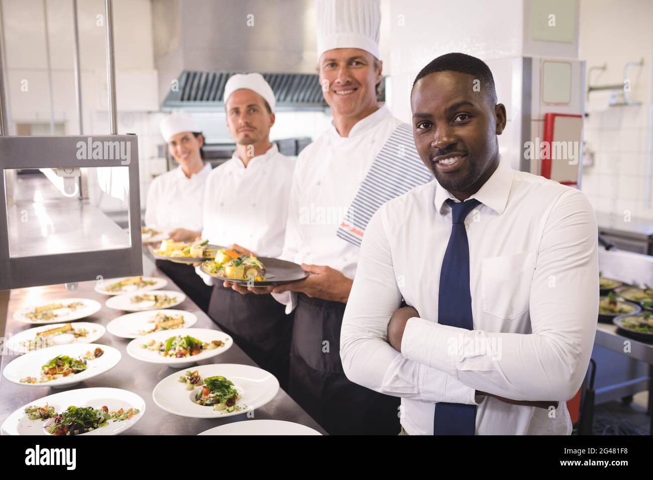 Restaurant manager with his kitchen staff Stock Photo Alamy