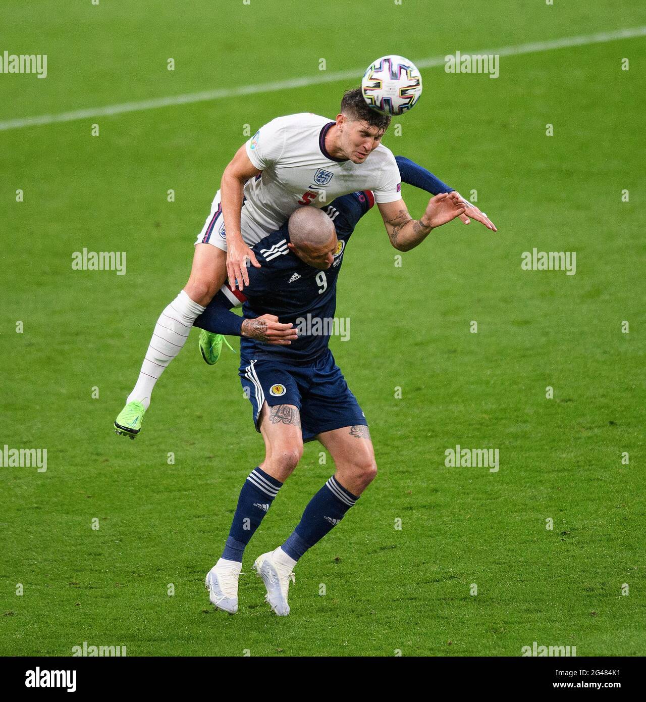 18th June 2021 - England v Scotland - UEFA Euro 2020 Group D Match - Wembley - London  John Stones in an aerial battle with Lyndon Dykes during England's match against Scotland in the UEFA European Championships 2020 Picture Credit : © Mark Pain / Alamy Live News Stock Photo