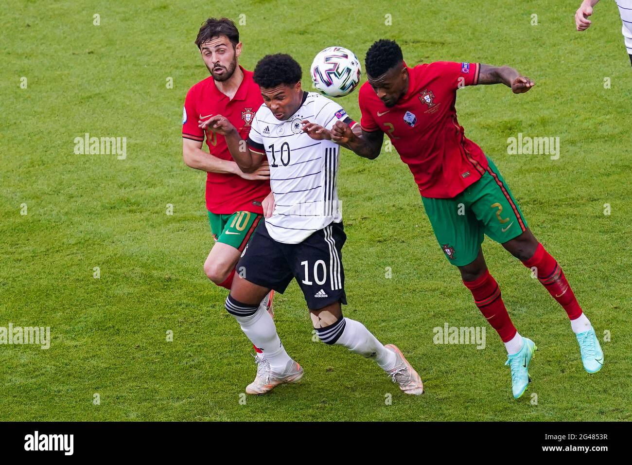 MUNCHEN, GERMANY - JUNE 19: Serge Gnabry of Germany battles for possession with Nelson Semedo of Portugal and Bernardo Silva of Portugal during the UEFA Euro 2020 Group F match between Portugal and Germany at Allianz Arena on June 19, 2021 in Munchen, Germany (Photo by Andre Weening/Orange Pictures) Stock Photo