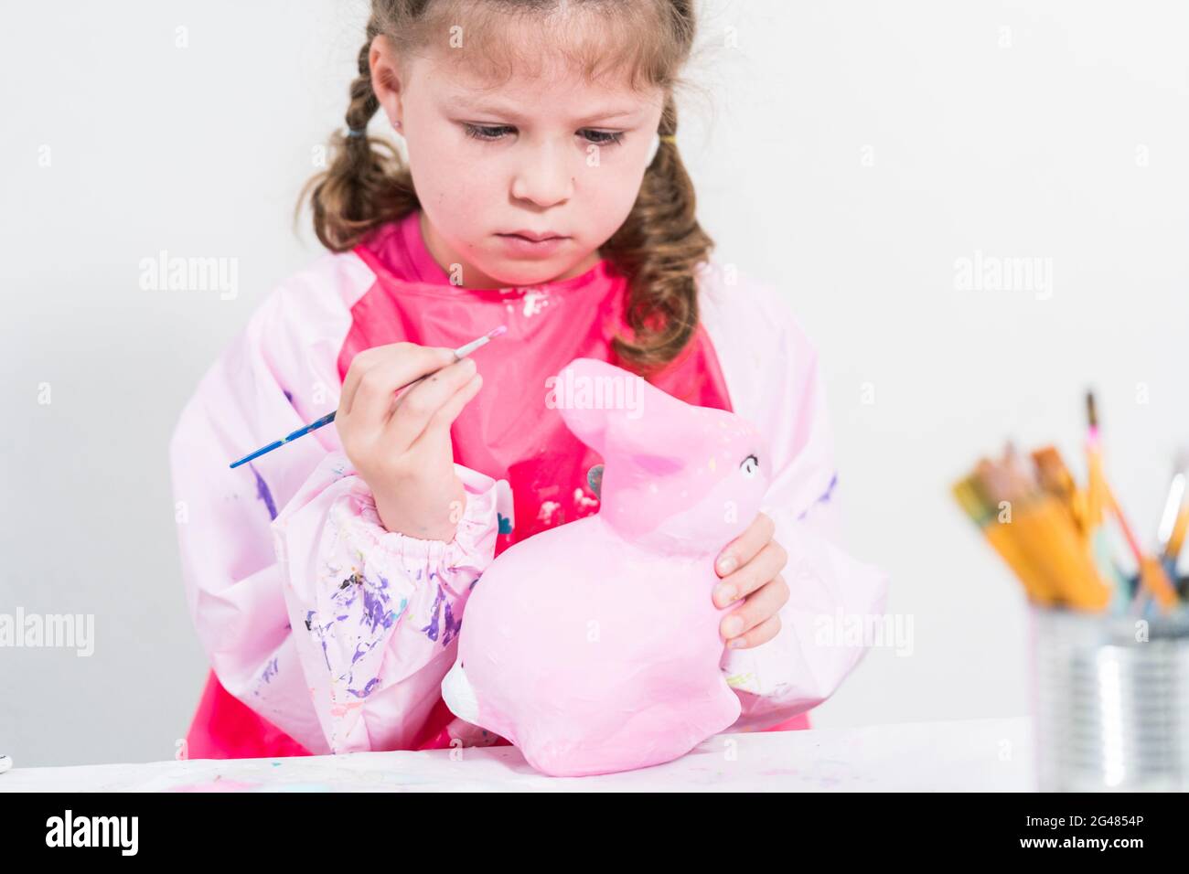 Homeschooling during COVID19 lockdown. Little girl painting paper