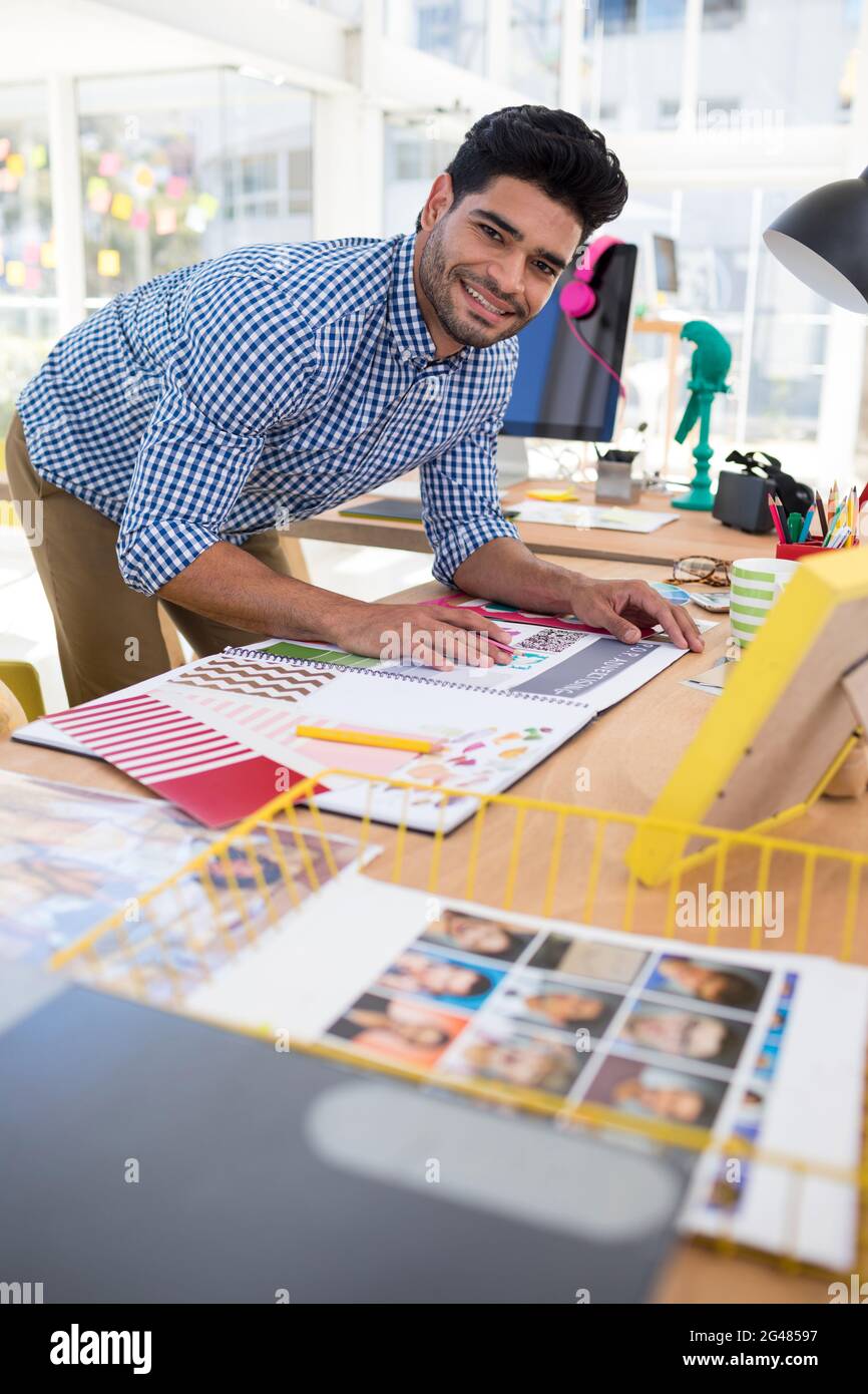 Male graphic designer working at desk Stock Photo