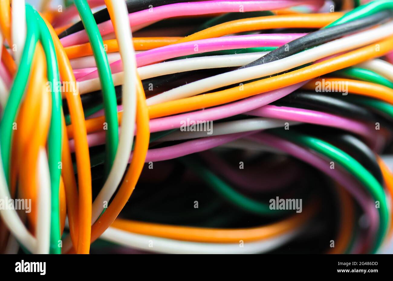 A bundle of multicolored electrical, car, computer, telephone twisted wires. Stock Photo