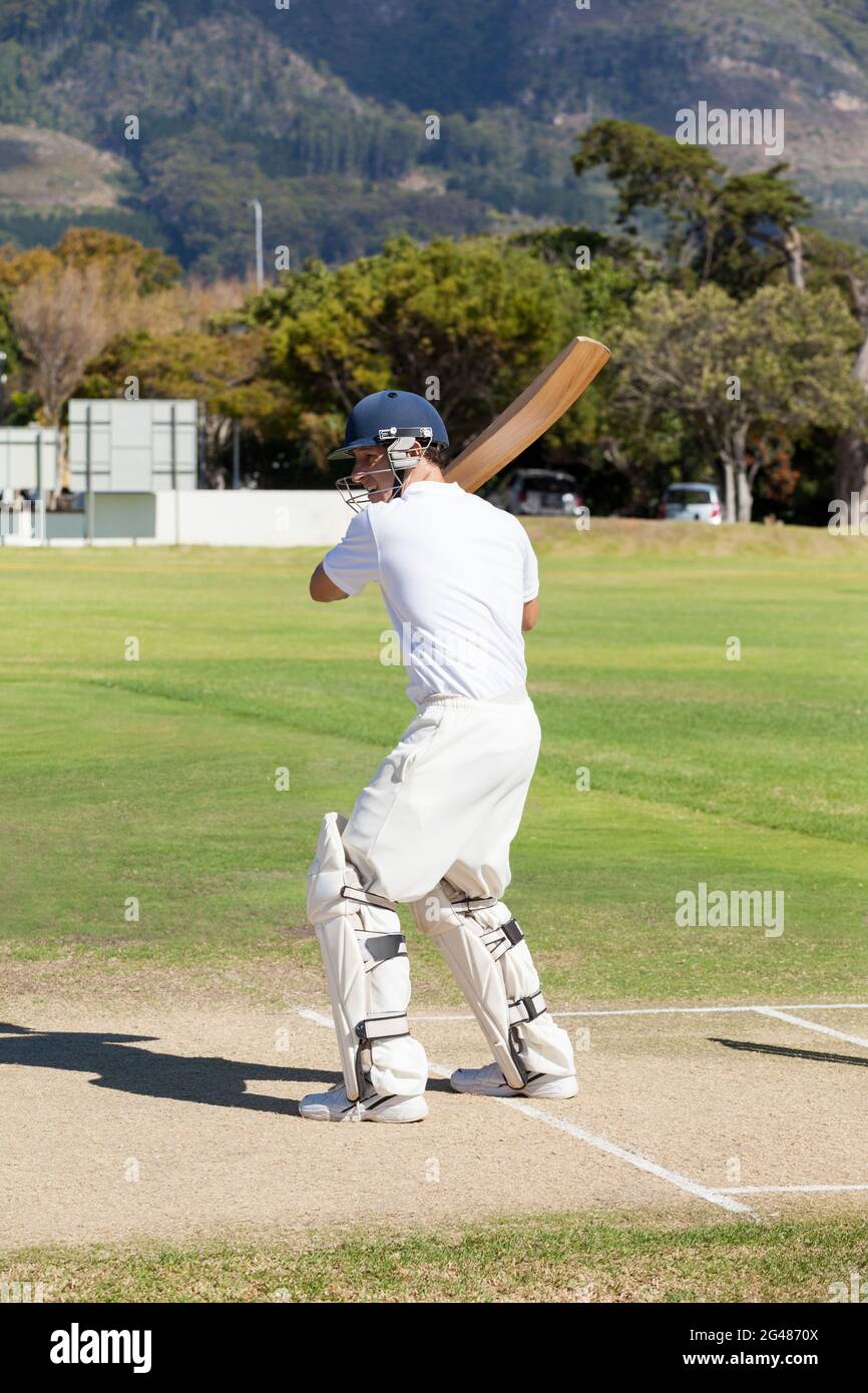 Cricket player standing holding bat hires stock photography and images