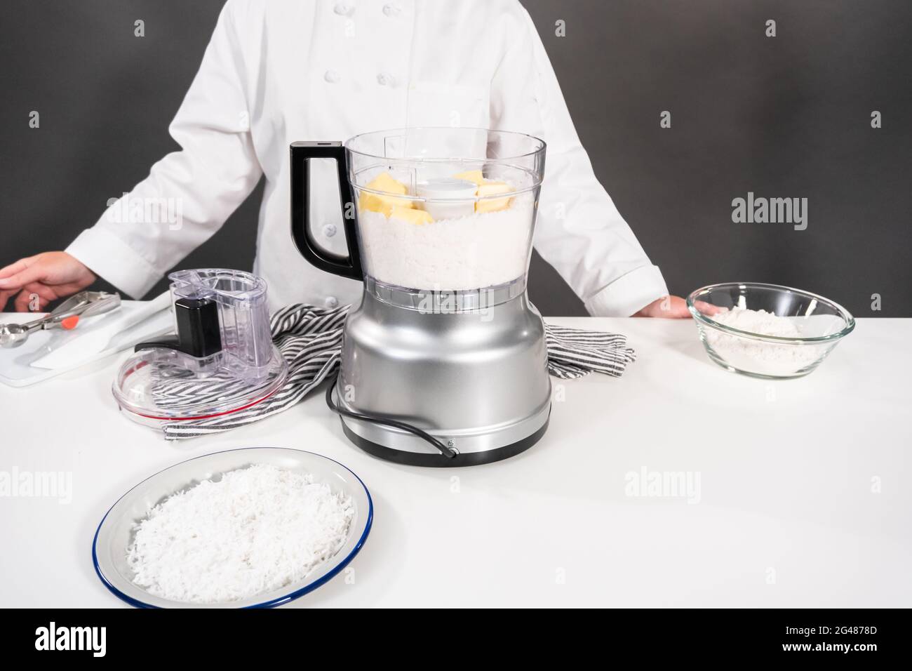 Mixing ingredients in the food processor to bake coconut cookies Stock ...