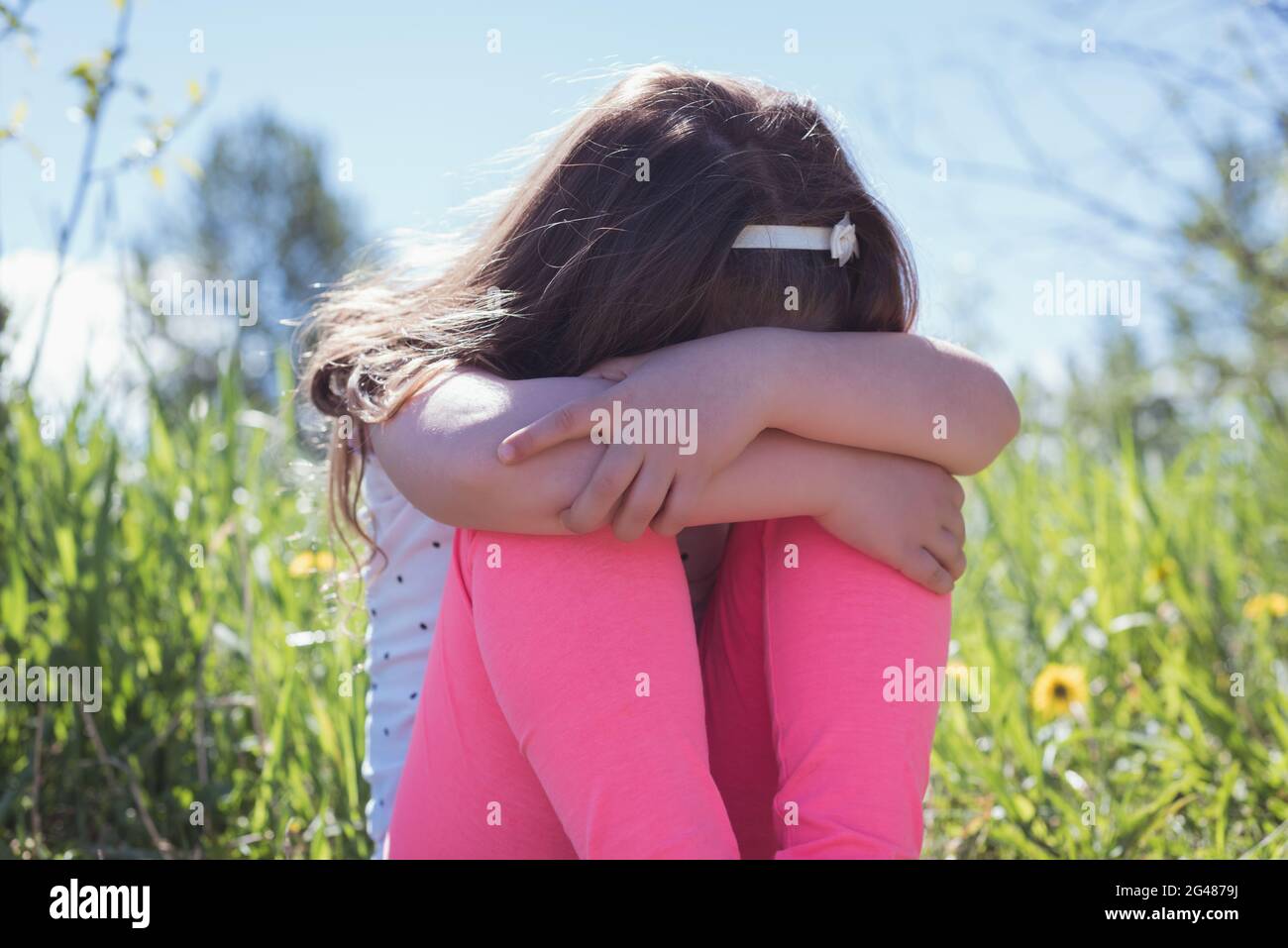 Sad girl sitting grass hi-res stock photography and images - Alamy