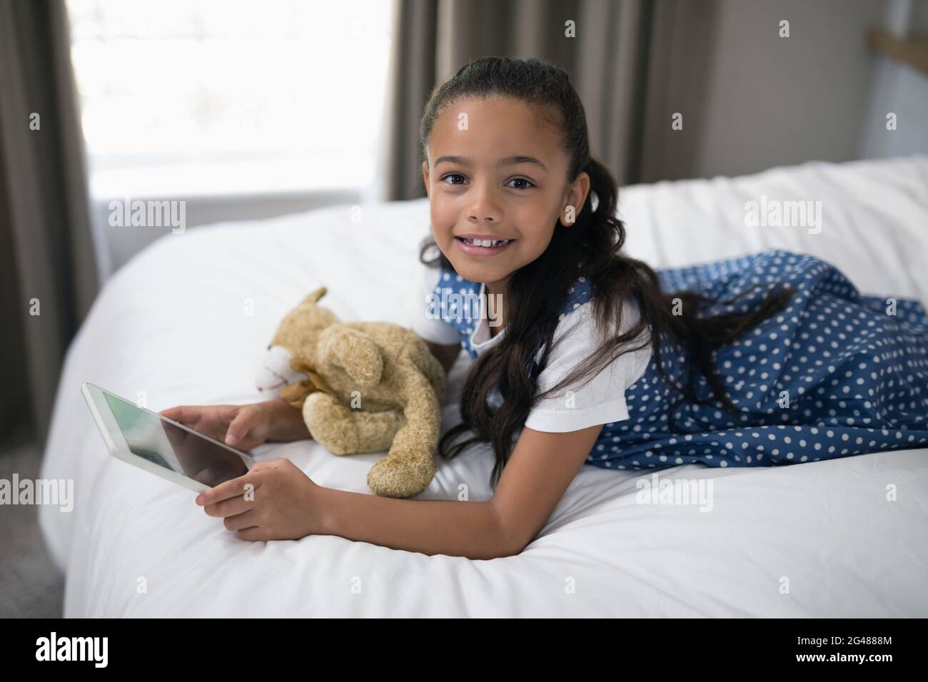 Girl tablet pc lying on hi-res stock photography and images - Alamy