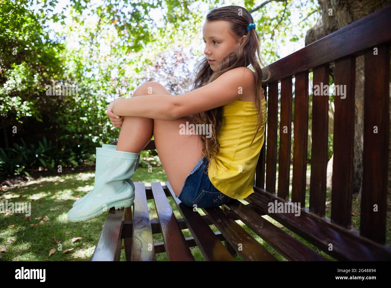 Thoughtful girl sitting on bench hi-res stock photography and images ...
