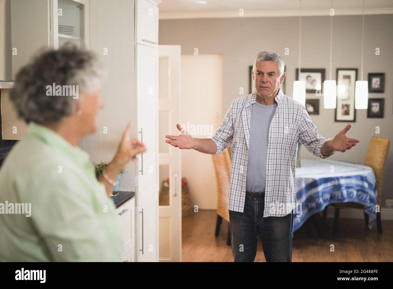 Angry senior man looking at female partner Stock Photo - Alamy