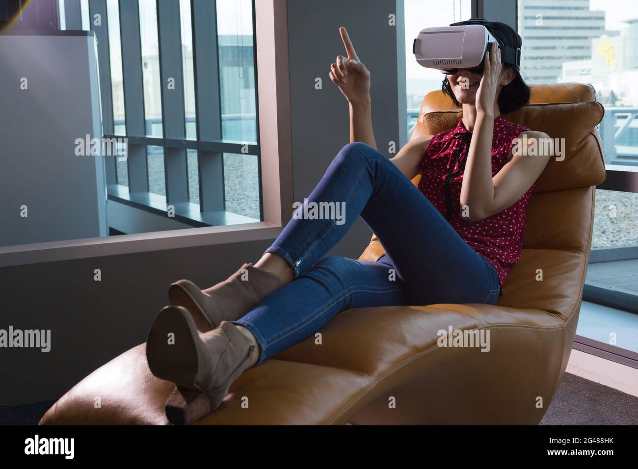 Female executive using virtual reality headset Stock Photo - Alamy