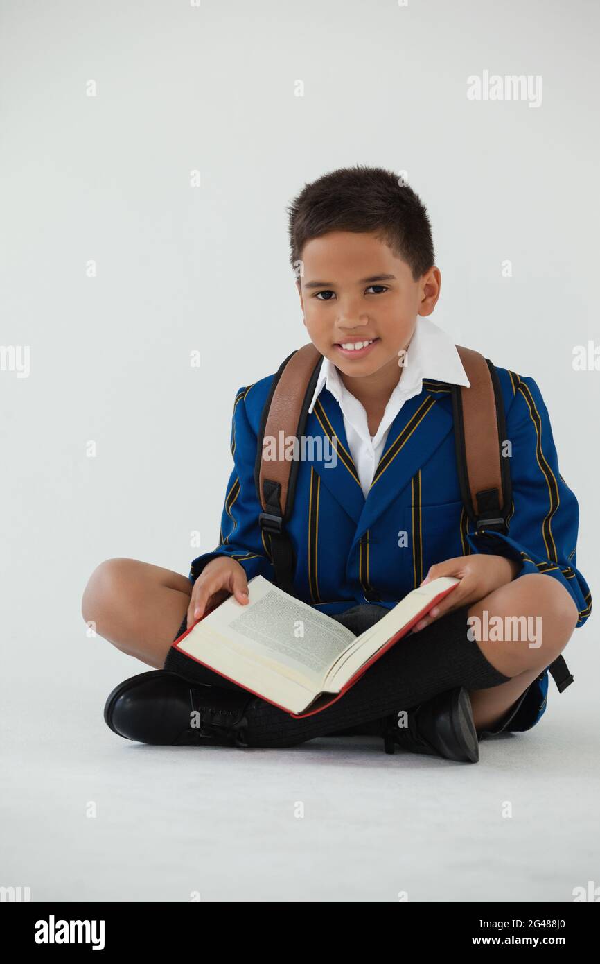Schoolboy reading book on white background Stock Photo - Alamy