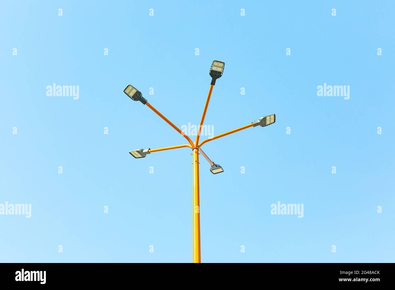 Five pointed outdoor street mast area lighting pole with LED lamps. Concept of modern lighting fixtures with copy space. Stock Photo