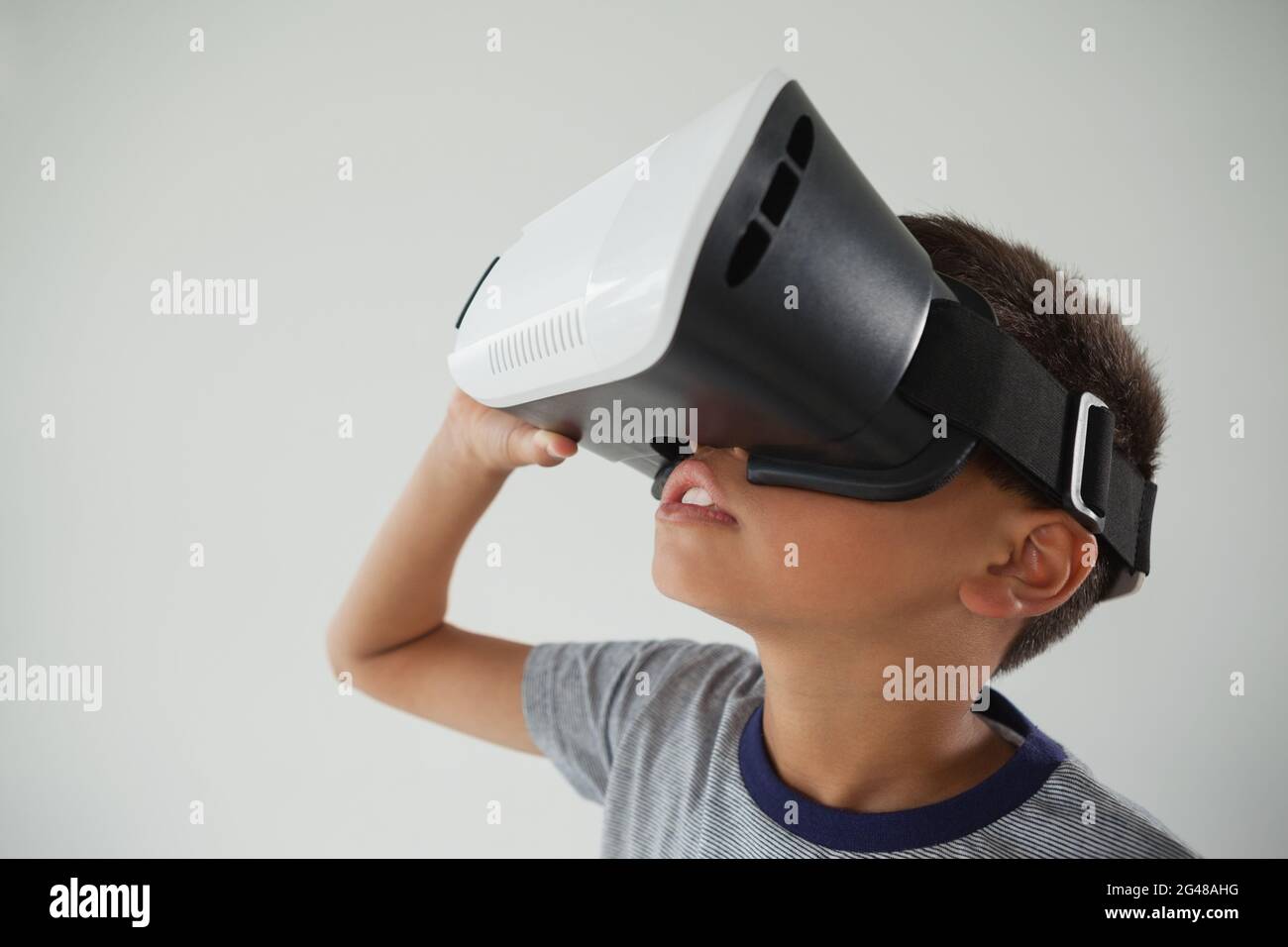 Schoolboy using virtual reality headset Stock Photo