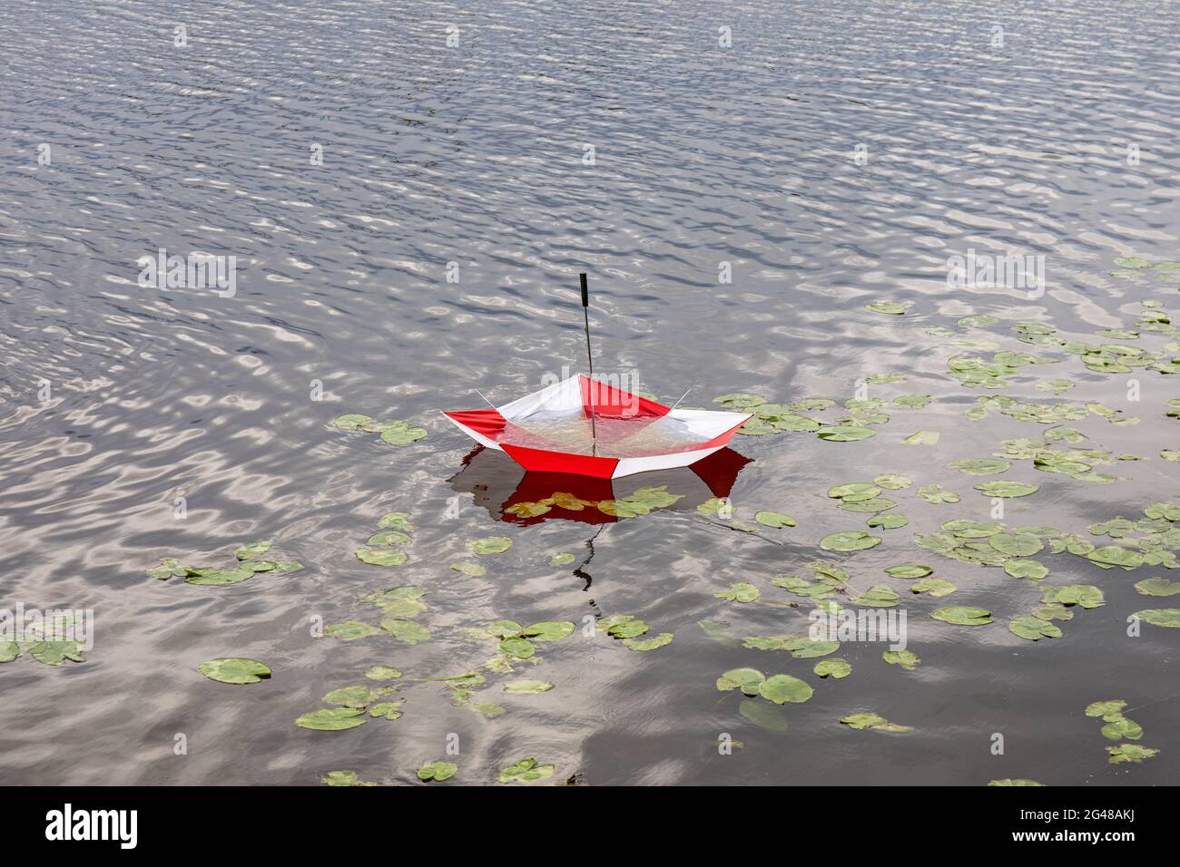 Broken umbrella floating in river in Porvoo, Finland Stock Photo
