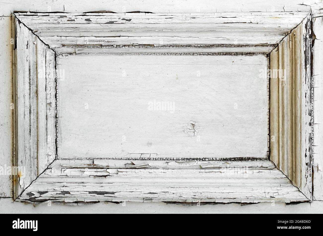 A white door panel with old weathered and cracked paint Stock Photo