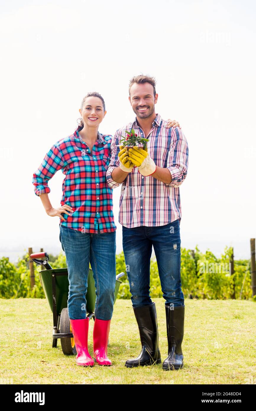 Portrait of man with woman holding potted plant Stock Photo - Alamy
