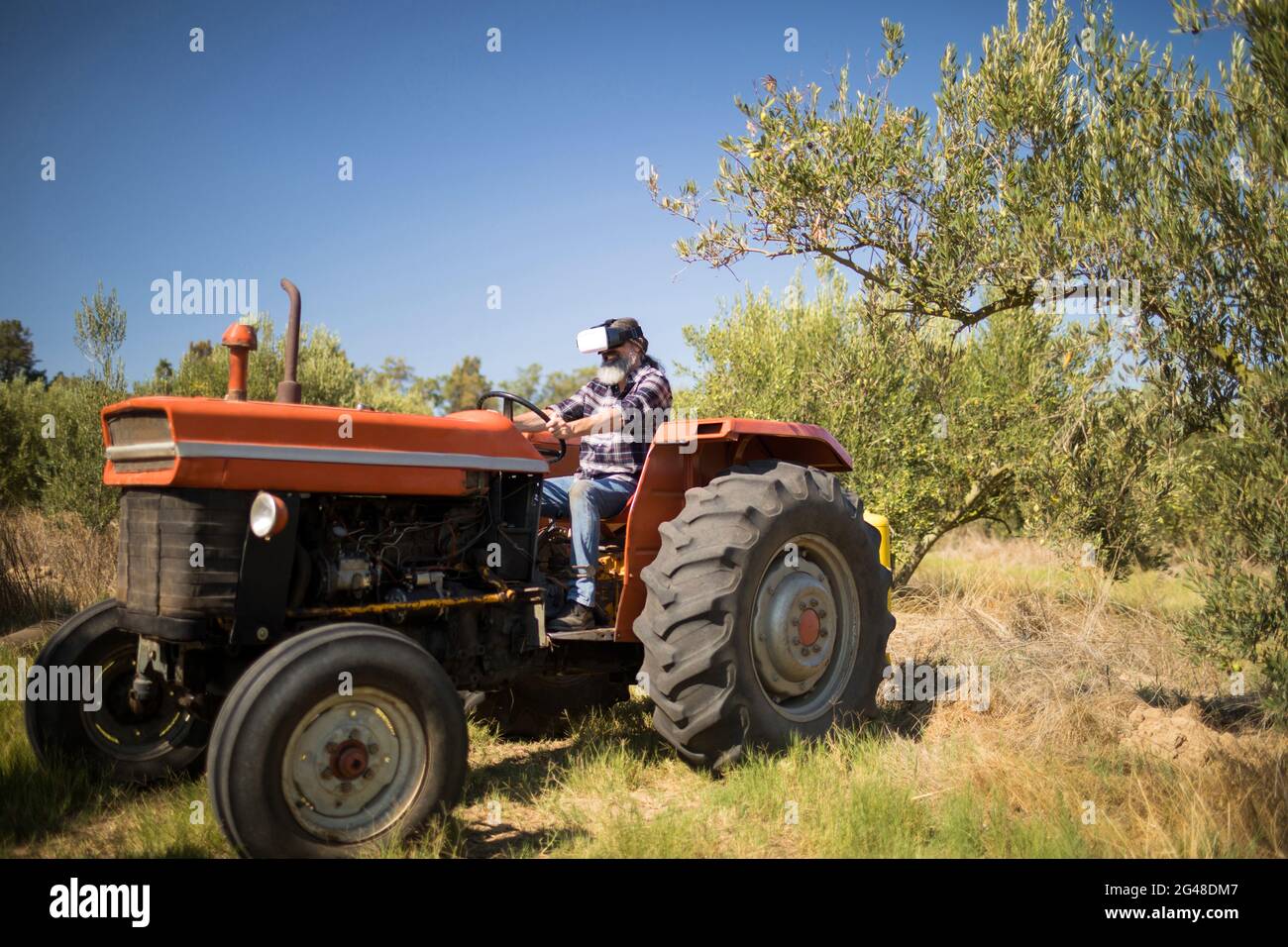 Man using virtual reality headset in tractor Stock Photo