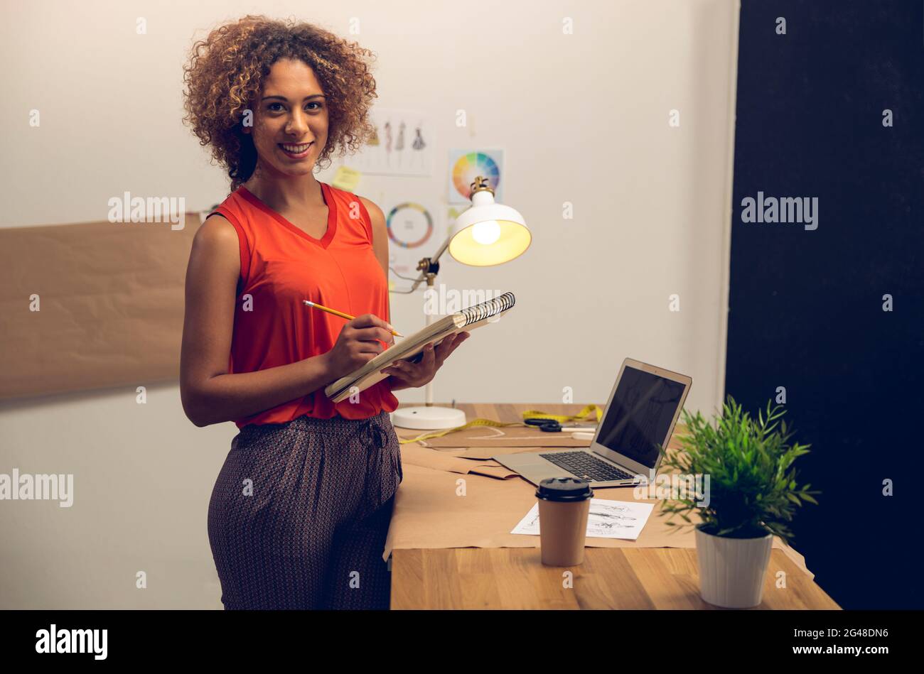 A young fashion designer working on her atelier Stock Photo - Alamy