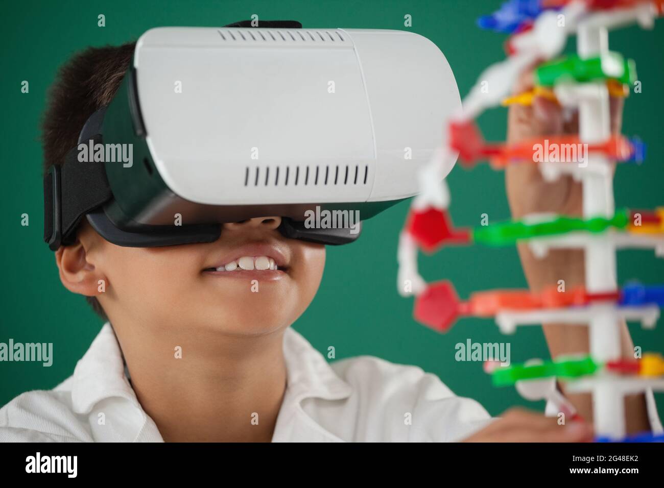 Schoolboy using virtual reality headset in laboratory Stock Photo