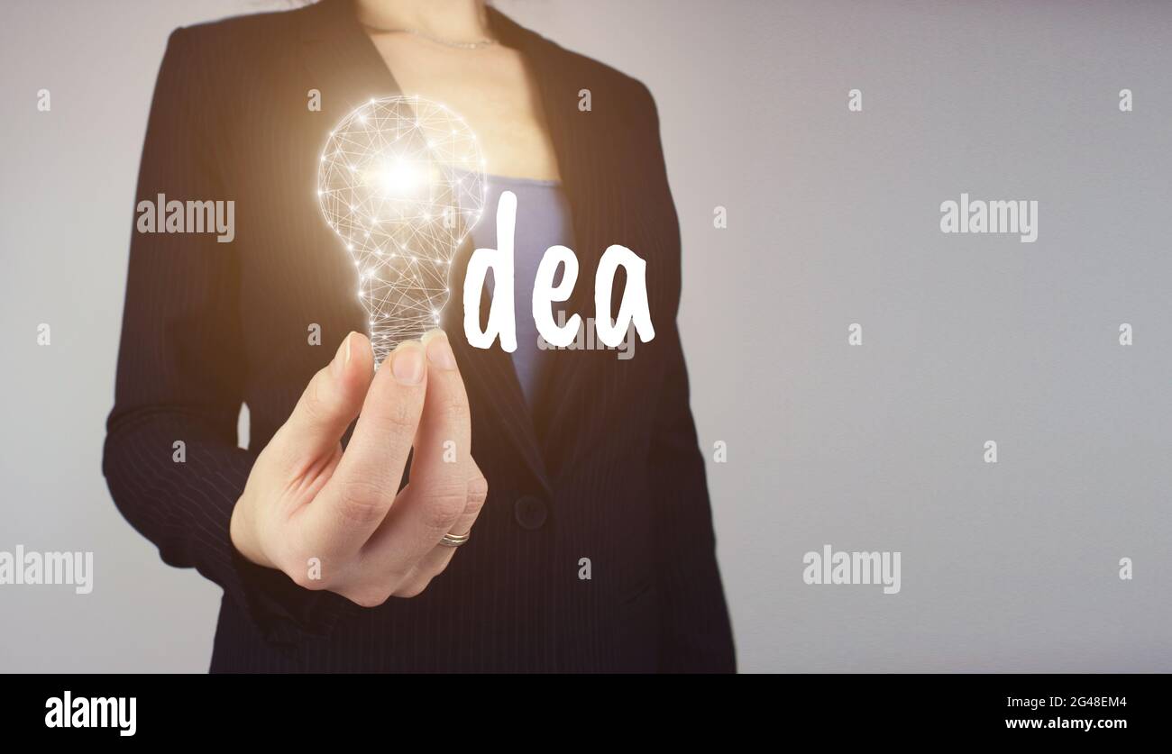 Creative new idea. Innovation, brainstorming. Hand hold digital light bulp with text IDEA. Concept of idea, innovation and Inspiration. Stock Photo
