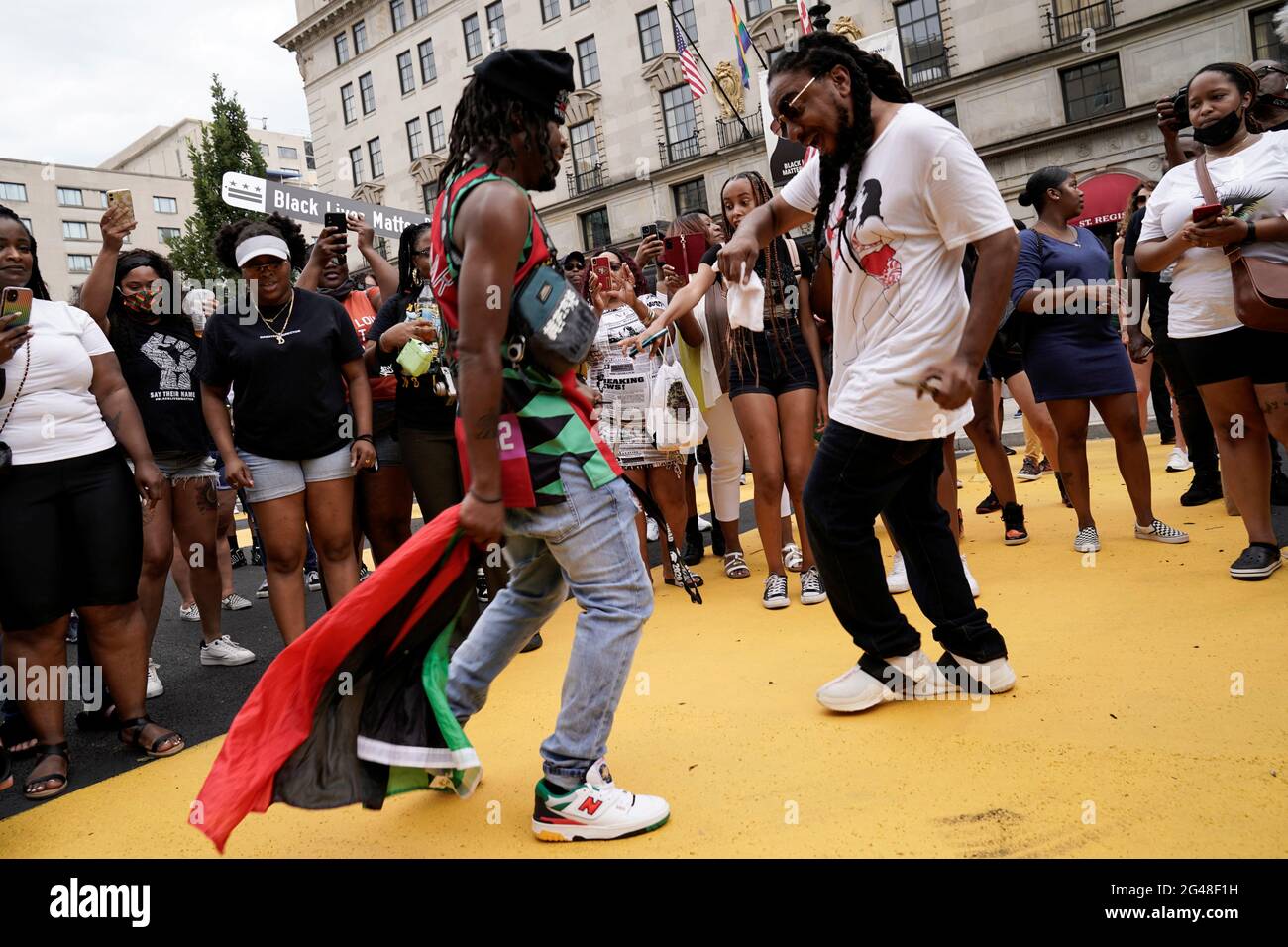 People celebrate Juneteenth, which commemorates the end of slavery in Texas, two years after the 1863 Emancipation Proclamation freed slaves elsewhere in the United States, at Black Lives Matter Plaza in Washington, D.C. U.S., June 19, 2021. REUTERS/Ken Cedeno Stock Photo