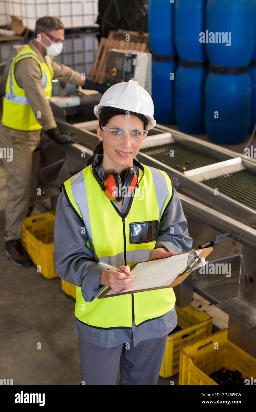 Technicians writing in clipboard Stock Photo