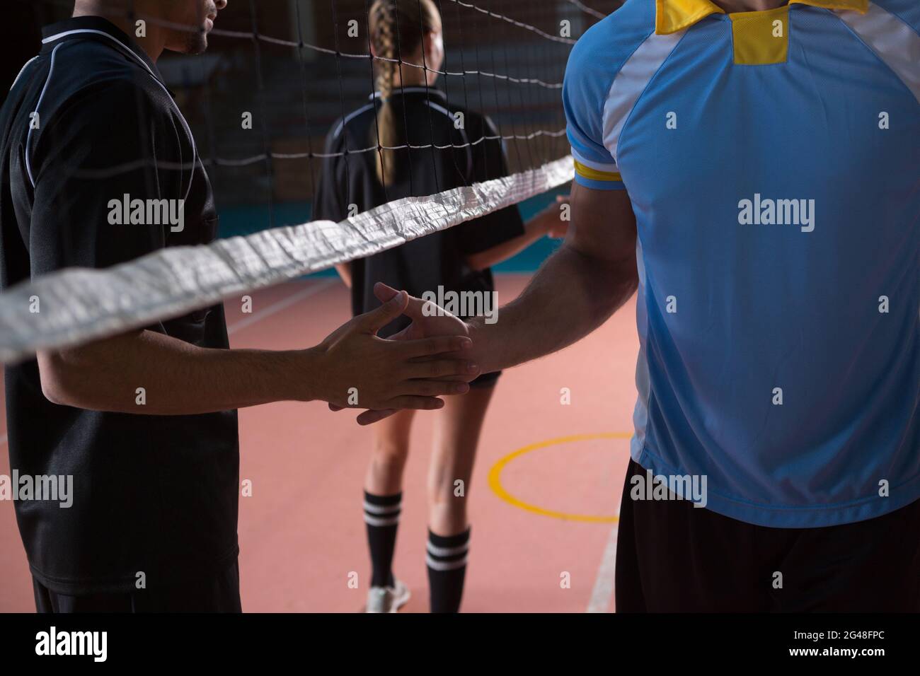 Male volleyball players shaking hands Stock Photo Alamy