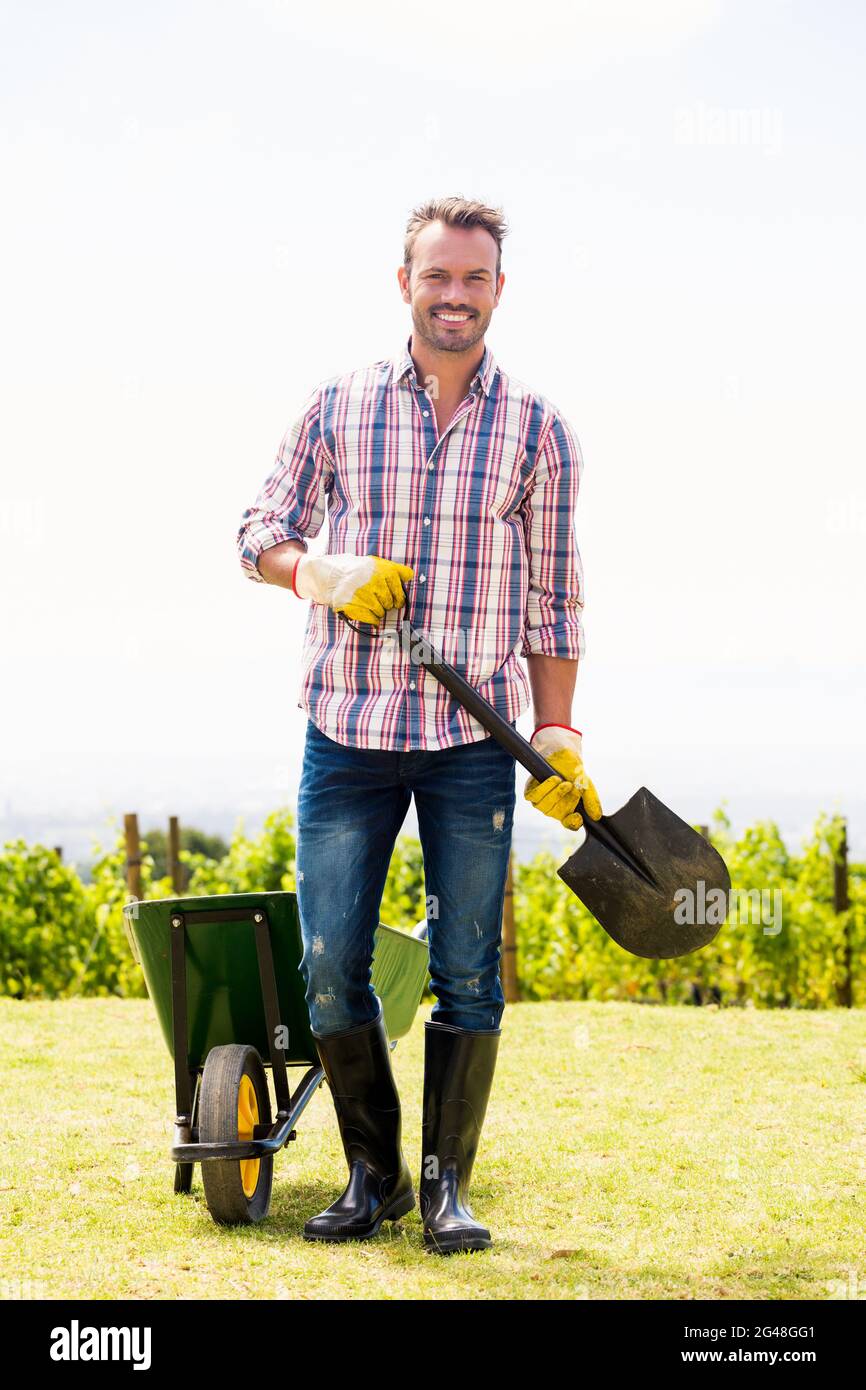 Man holding shovel hires stock photography and images Alamy