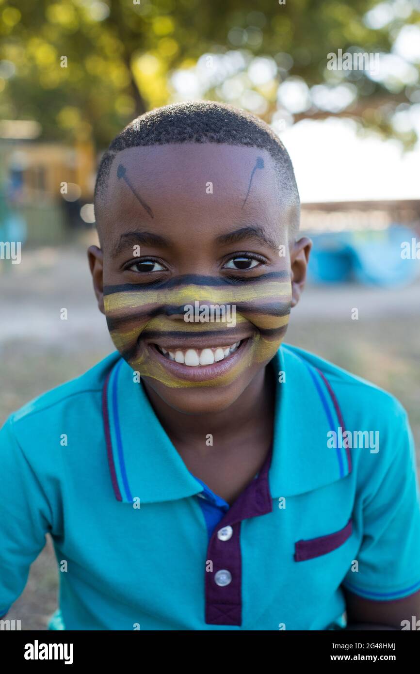 Portrait of happy boy with face paint Stock Photo