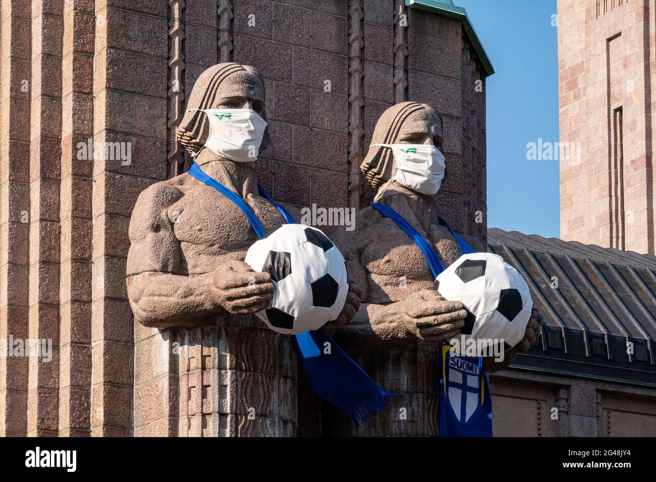 Helsinki Central Railway Station statues wearing facemasks and holding footballs to celebrate European Football Championship games Stock Photo