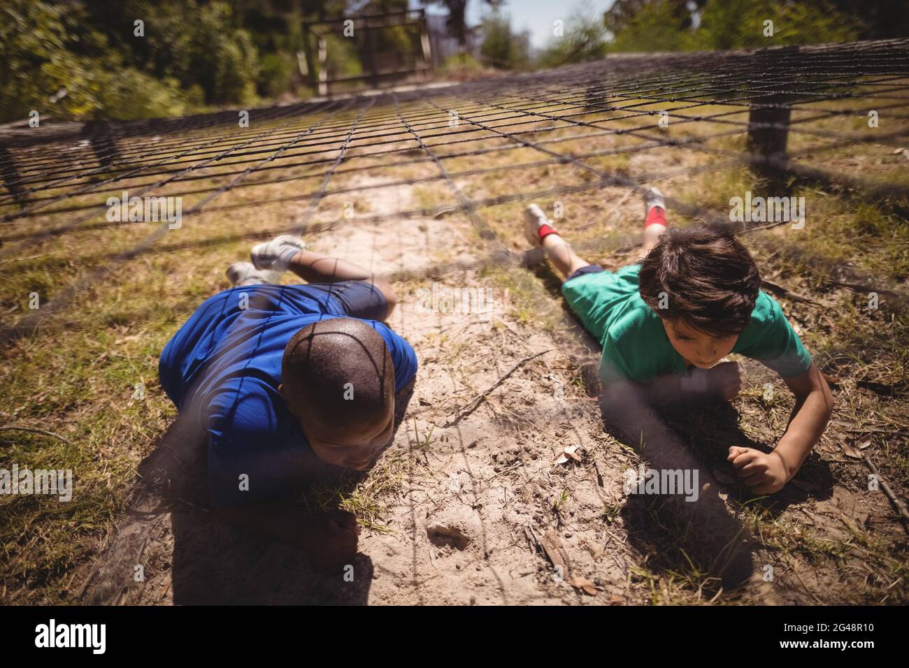 Kids Crawling Under The Net During Obstacle Course Stock Photo Alamy