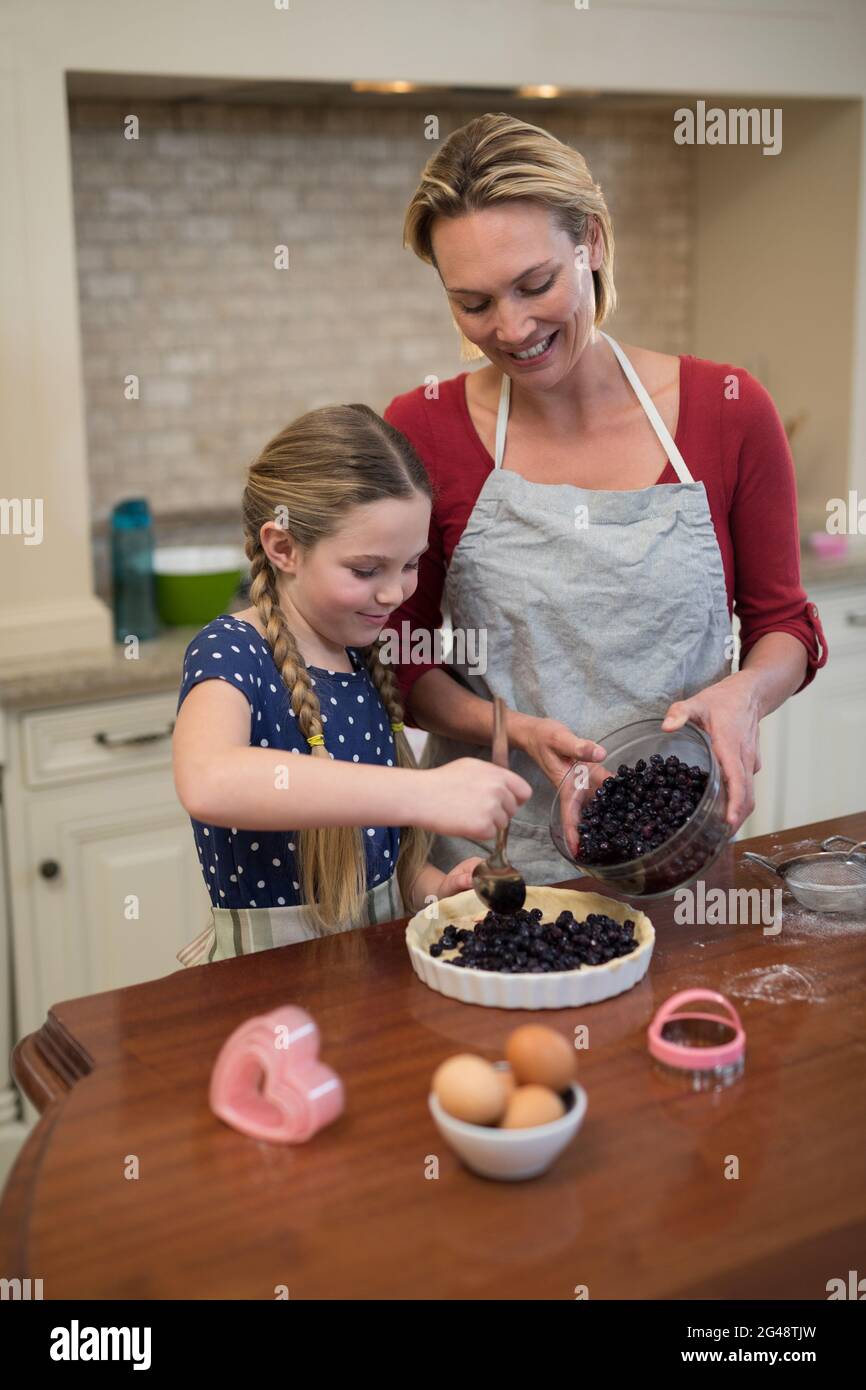 Mother and daughter preparing blue berry pie Stock Photo
